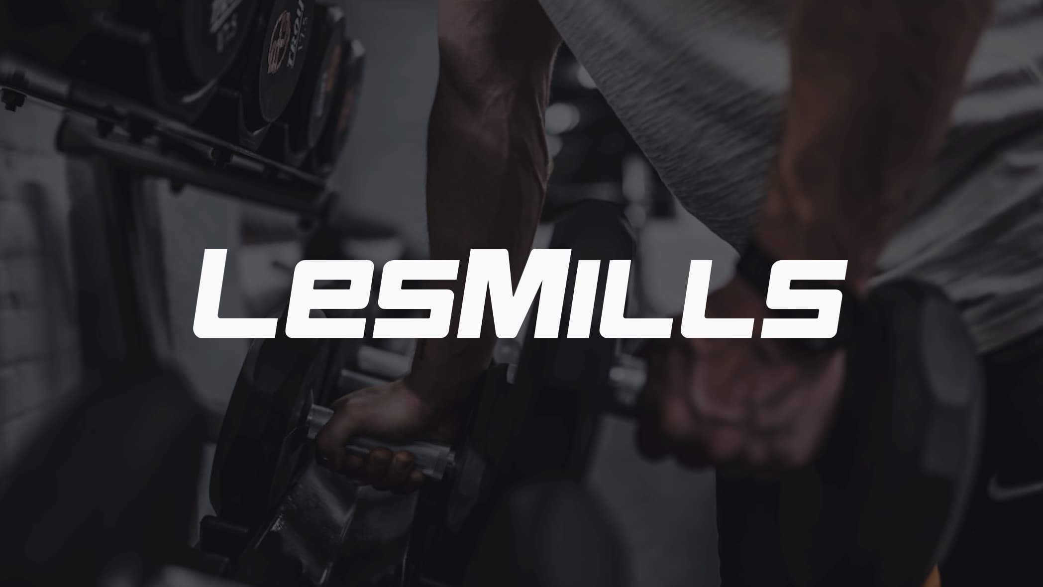 Les Mills logo with person lifting weights in background